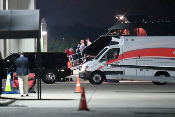 A person believed to be Otto Warmbier is transferred from a medical transport airplane to an awaiting ambulance at Lunken Airport in Cincinnat