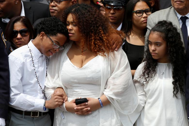 Family members of slain New York City Police Department (NYPD) officer Miosotis Familia stand outside the World Changers Church following her funeral service in the Bronx borough of New York City