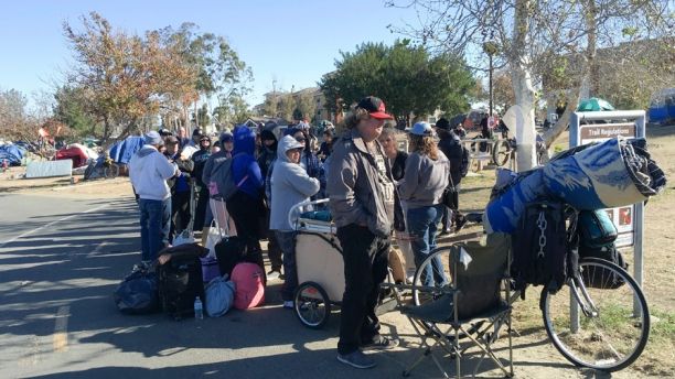 Homeless people prepare to move from their camp