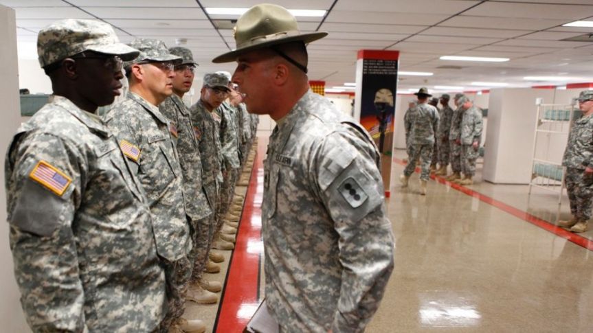 A drill sergeant scolds one of his recruits