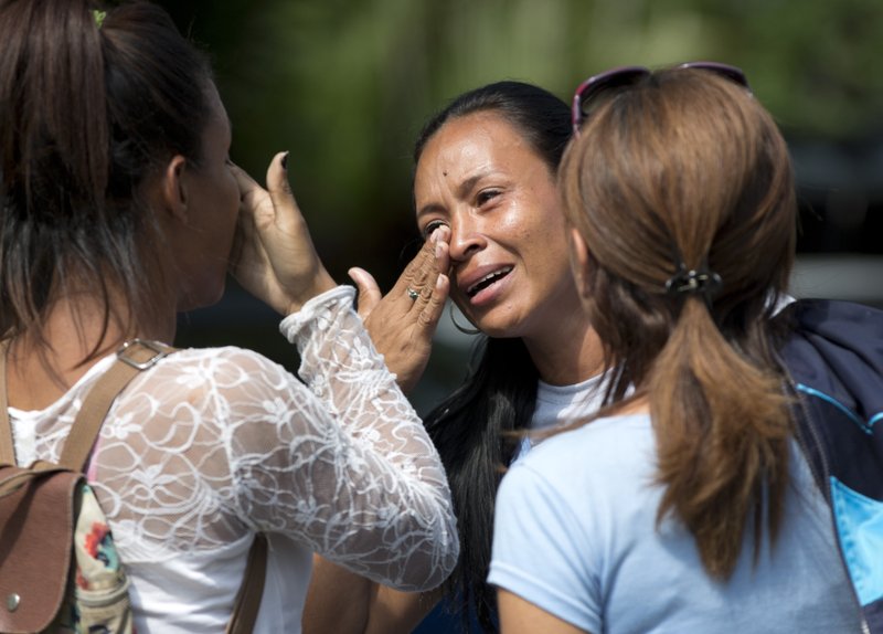 Tormented relatives of 68 people killed in a fire at a Venezuelan police station jail