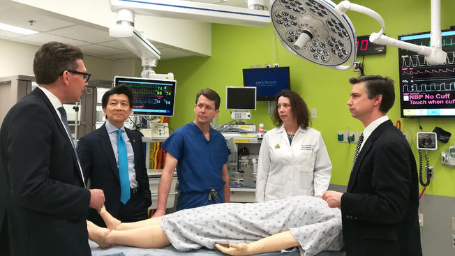 The team of surgeons gather around a mannequin at Johns Hopkins,