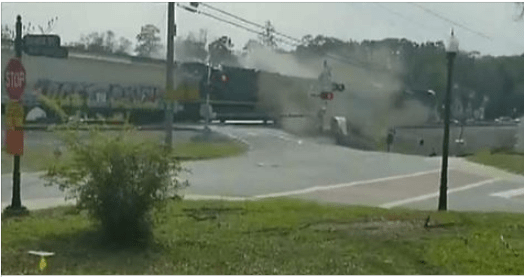 A freight train plowed into a semi-truck stuck