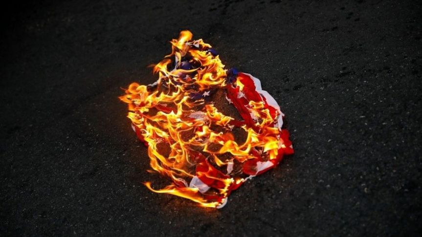 Police arrested three May Day protesters for setting fire in a city park,