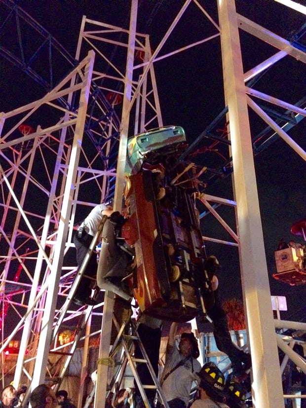 Daytona Beach firefighters work to rescue two rollercoaster riders after their car derailed on the Daytona Beach boardwal