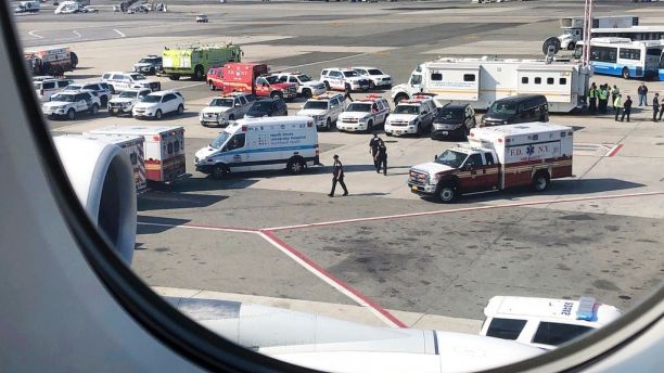 Emergency response crews gather outside a plane at New York's Kennedy Airport