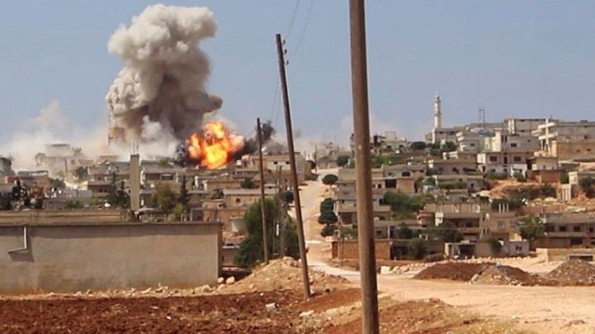 shows flames and smoke rising from a Syrian government airstrike, in Hobeit village,