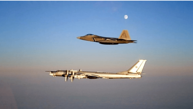 An F-22 Raptor escorts a Russian TU-95 Bear