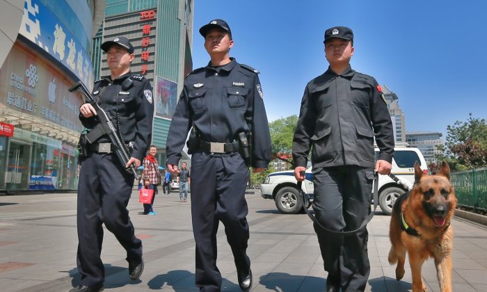 Armed police officers patrol a street in Beijing, China