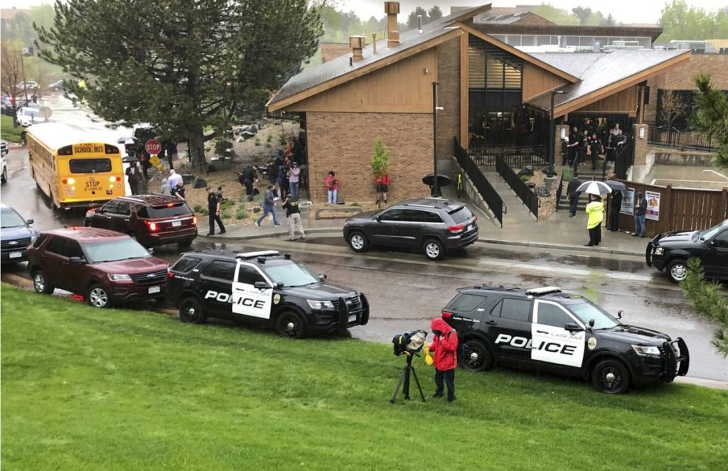 Police and others are seen outside a recreation center