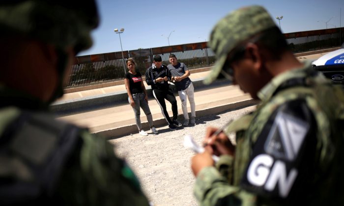 Members of Mexico's National Guard detain Cuban migrants