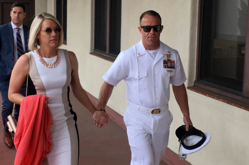 Navy Special Operations Chief Edward Gallagher, right, walks with his wife, Andrea Gallagher