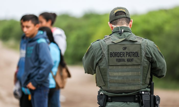 A Border Patrol agent apprehends illegal aliens