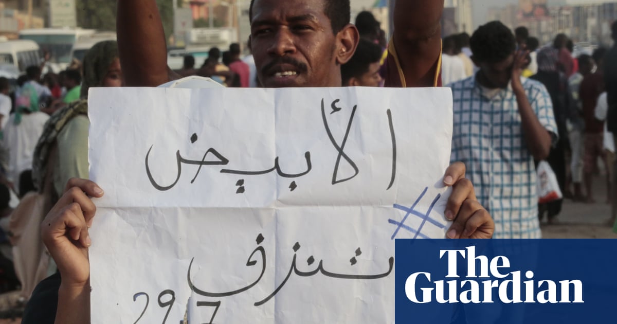 A man holds a placard saying ‘El-Obeid is bleeding’ in a protest in Khartoum against the killings. 