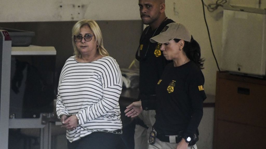 Federal agents escort former Puerto Rico Health Insurance Administration head Ángela Ávila-Marrero, who was arrested in San Juan, Puerto Rico,