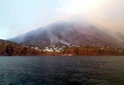 Smoke billows from the volcano on the Italian island of Stromboli, Wednesday, July 3, 2019. 