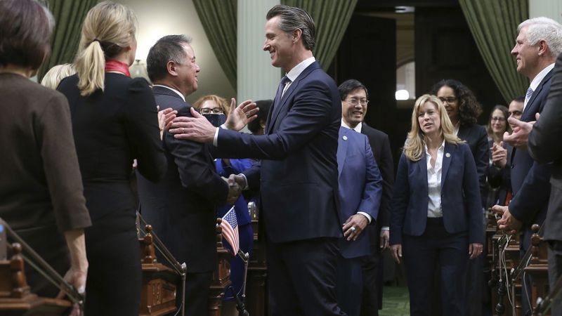 California Gov. Gavin Newsom, center, shakes hands with Assemblyman Phil Ting (D-San Francisco) 