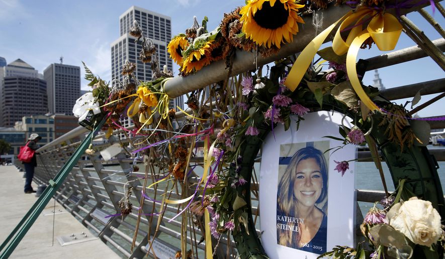 In this July 17, 2015, photo, flowers and a portrait of Kate Steinle remain at a memorial site on Pier 14 in San Francisco.