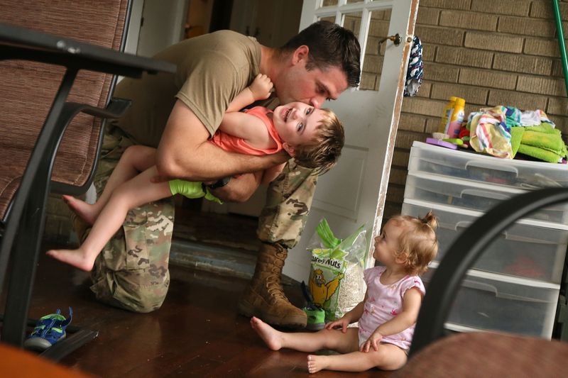 Jonathan Logemann plays with his two daughters, Eleanor, 3, and Maya, 1,
