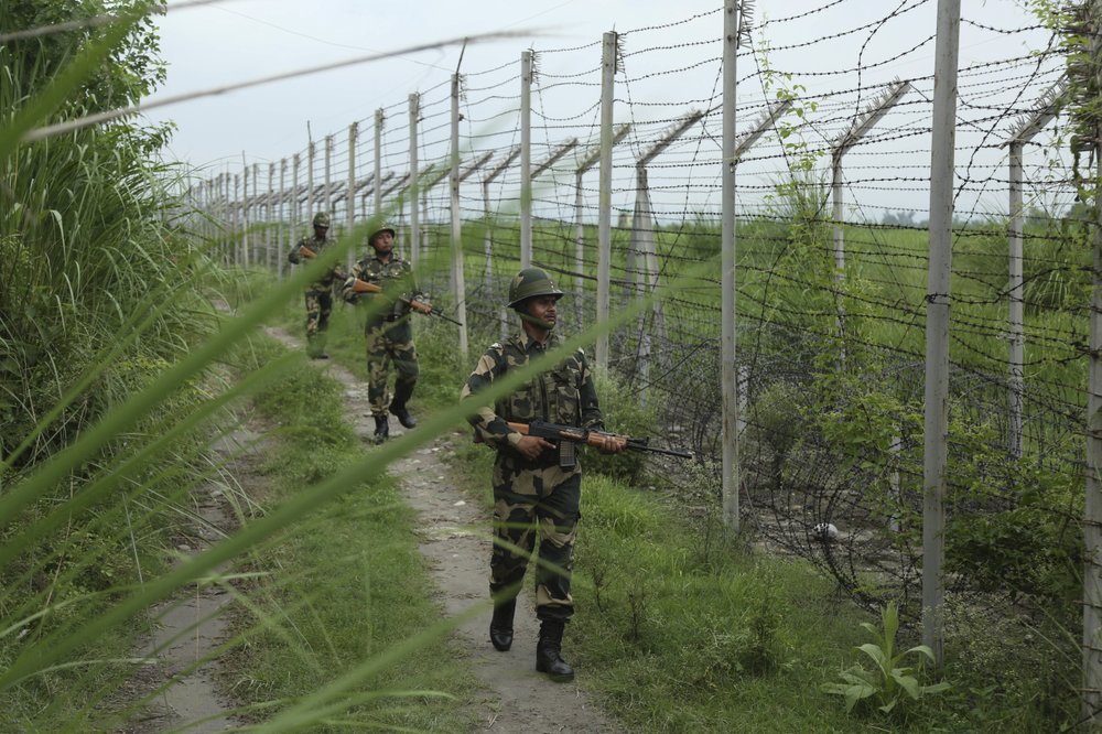 India's Border Security Force (BSF) soldiers patrol near the India Pakistan border fencing at Garkhal in Akhnoor, 