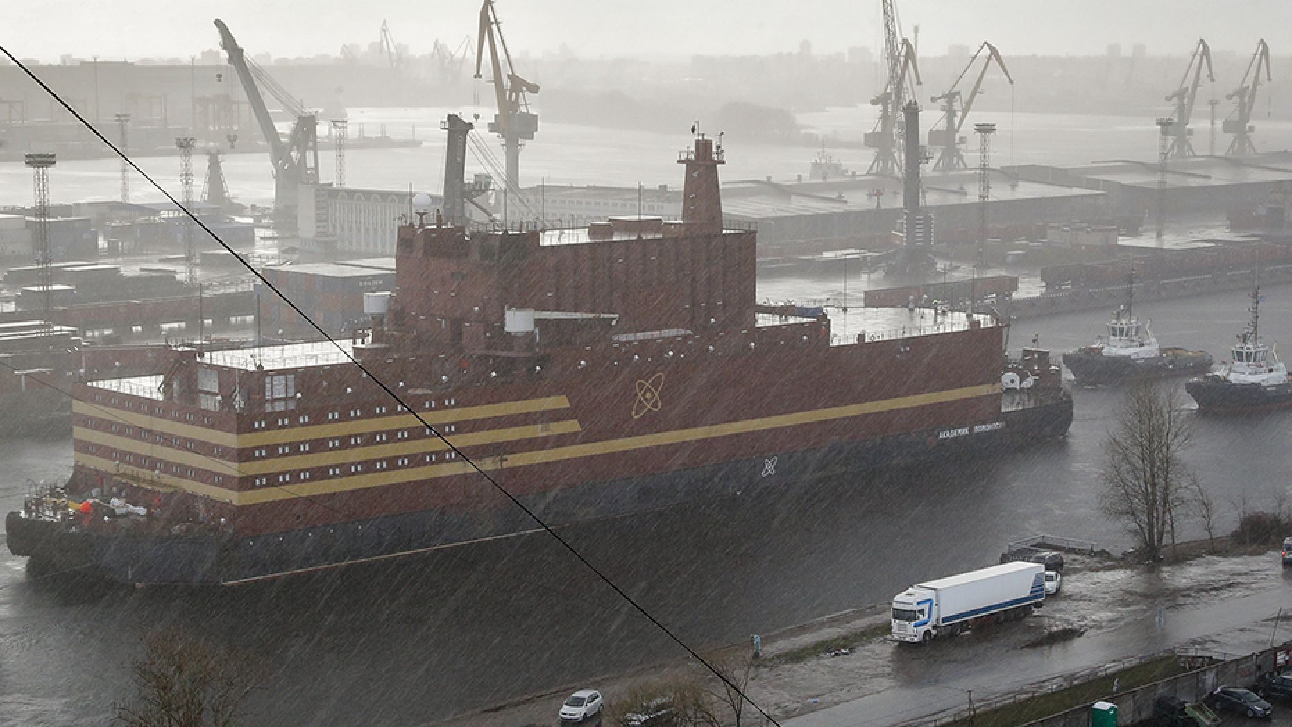 The floating nuclear power plant Akademik Lomonosov is towed out of the shipyard where it was constructed in St. Petersburg, Russia, in April 2018.