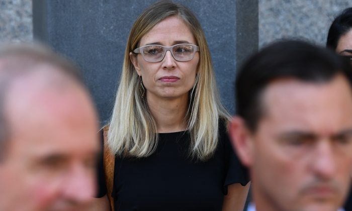 Annie Farmer, an alleged victim of convicted sex offender Jeffrey Epstein, stands behind lawyers at a press conference in New York City on July 15, 2019.