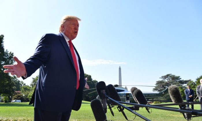 US President Donald Trump speaks to the press on the South Lawn of the White House before departing in Washington, DC 