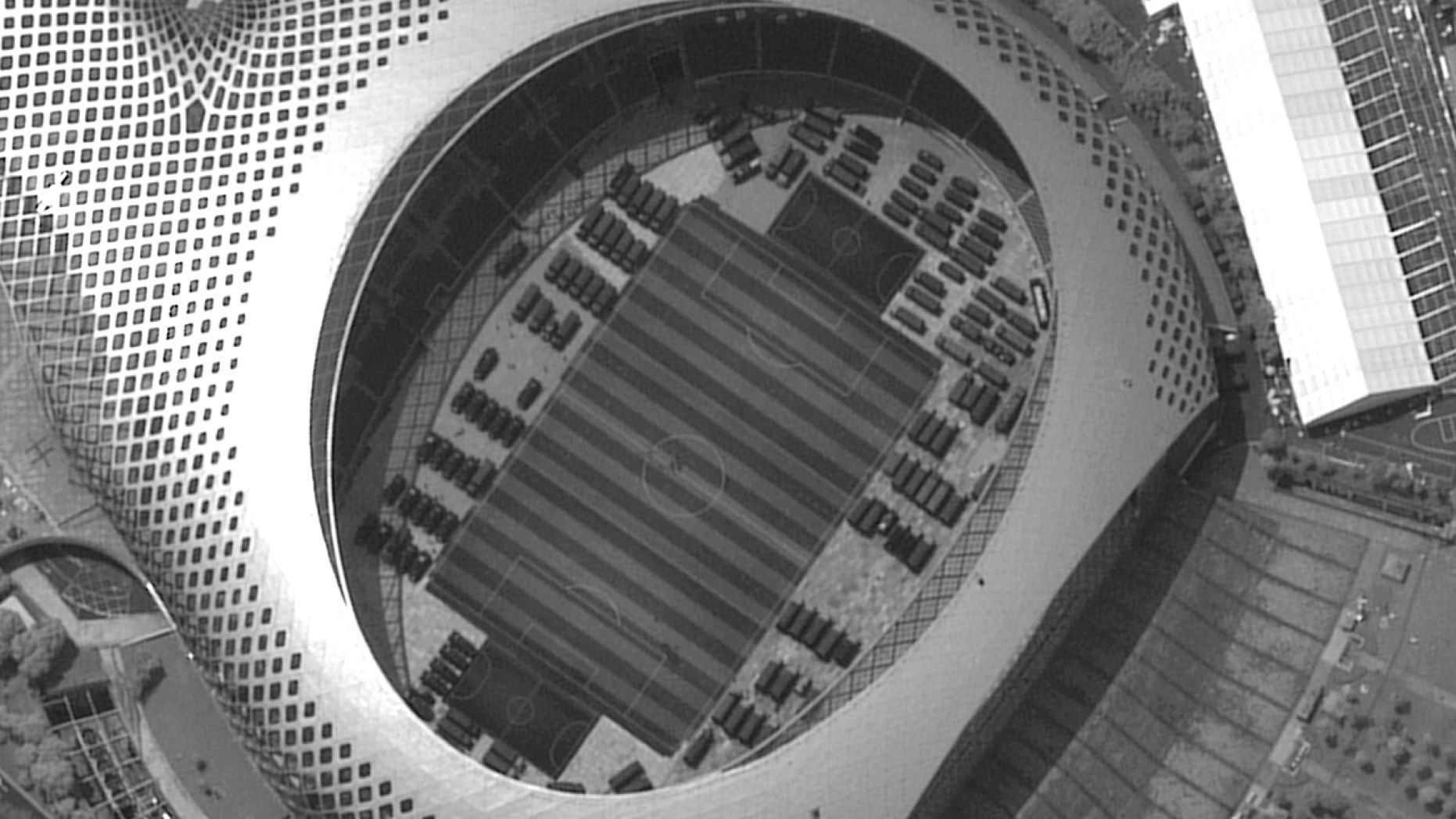 This satellite image captured on Monday, Aug. 12, 2019, provided by Maxar Technologies appears to show Chinese security force vehicles inside the Shenzen Bay Sports Center in the southern Chinese city of Shenzhen, bordering Hong Kong.