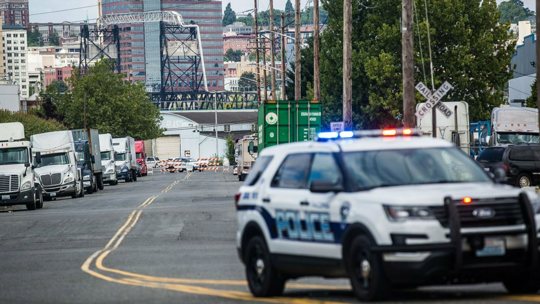 A police officer guards the front of a road block near the Northwest Detention Center Saturday in Tacoma, Wash