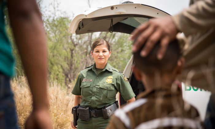 Supervisory Border Patrol agent Marlene Castro speaks to a group of illegal aliens 