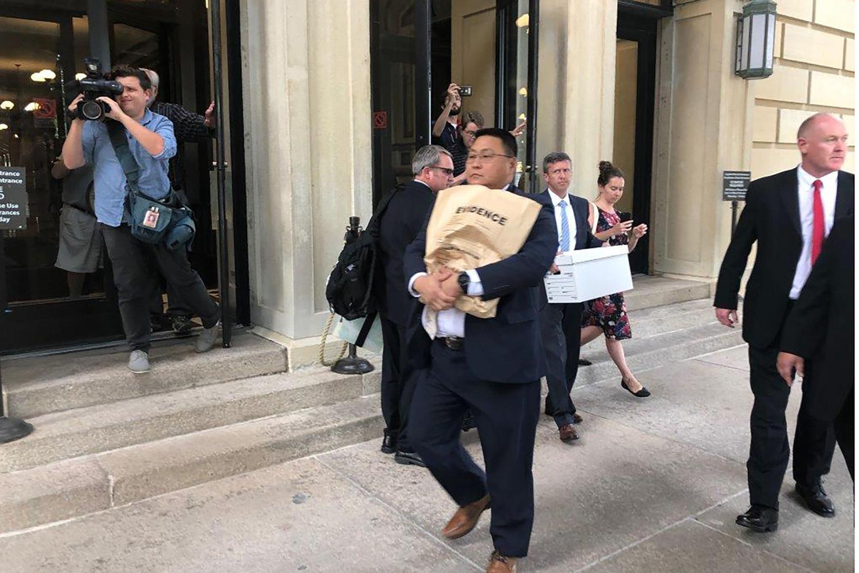 An unidentified man carries a box marked "evidence" as he leaves the Illinois State Capital in Springfield Ill., Tuesday, Sept. 24, 2019. An FBI spokesman says agents are at the Illinois state Capitol building in Springfield related to law enforcement work. 