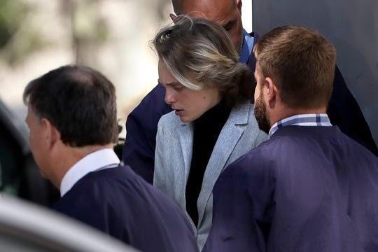 Michelle Carter, center, departs following a parole hearing on Thursday, Sept. 19, 2019 in Natick, Mass. 
