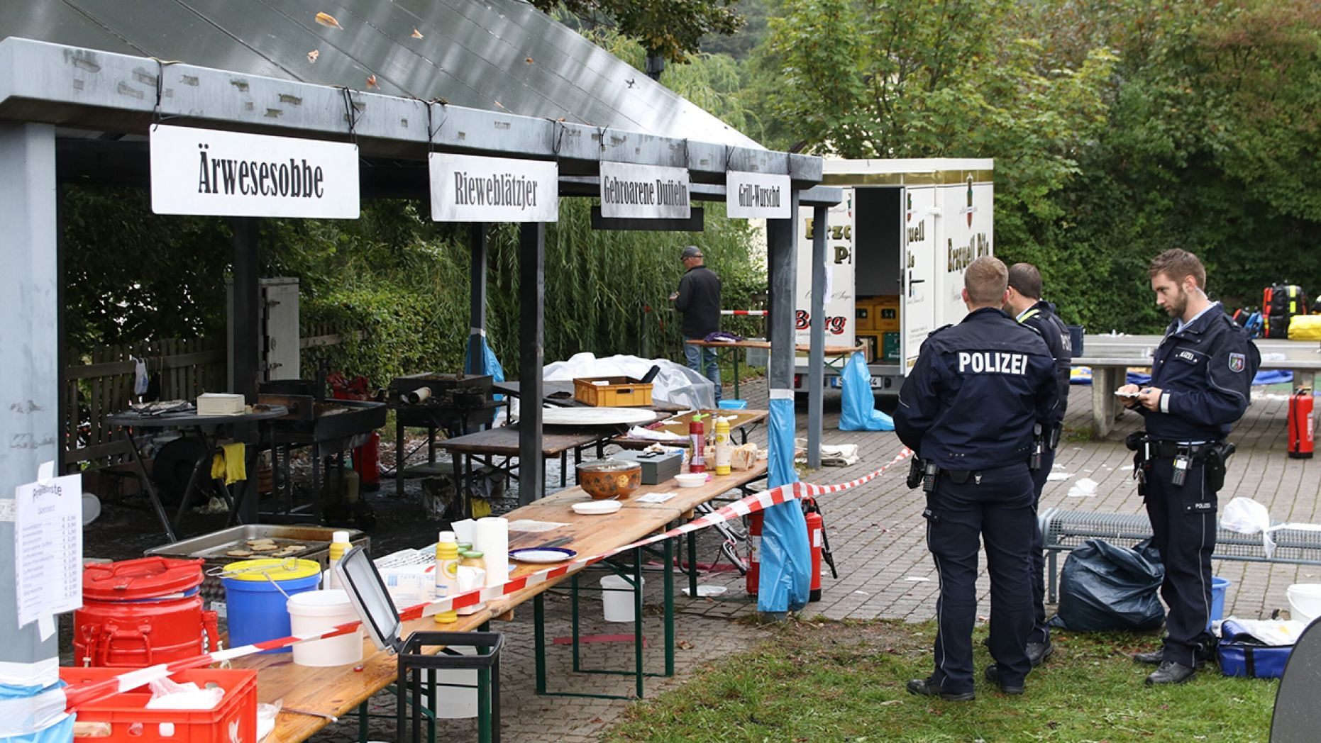 In this Sunday, Sept. 8, 2019 photo police officers investigate a booth after an explosion at a village festival in Freudenberg, Germany.