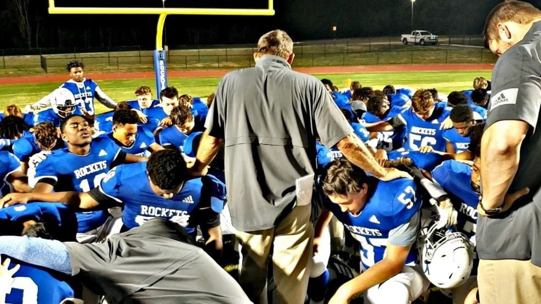 Rockvale High School Football Coach Rick Rice leads a team prayer, a practice that came under fire from the Freedom From Religion Foundation. 