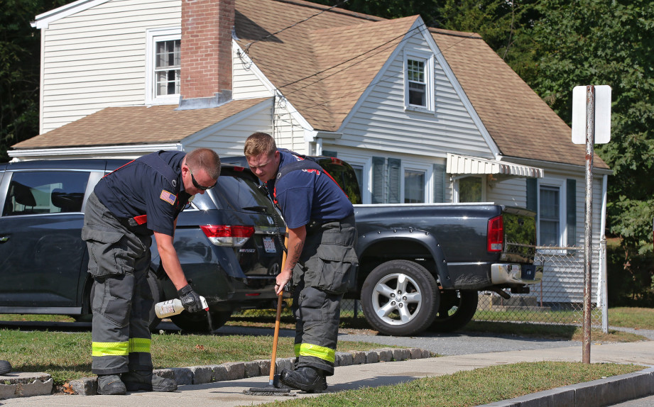 WALTHAM MA. – SEPTEMBER 23: Firefighters clean the sidewalk at the scene of a double stabbing on Wheelock Rd . on September 23, 2019 in Waltham, MA. 