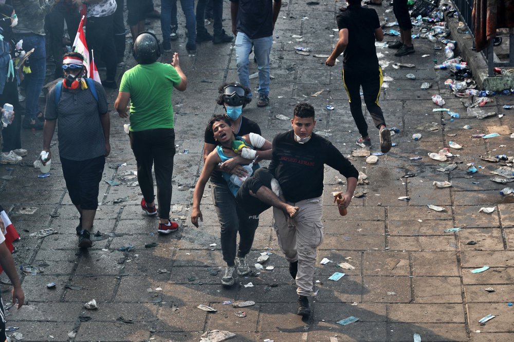 An injured protester is rushed to a hospital during anti-government demonstrations in Baghdad, Iraq, Tuesday, Oct. 29, 2019.