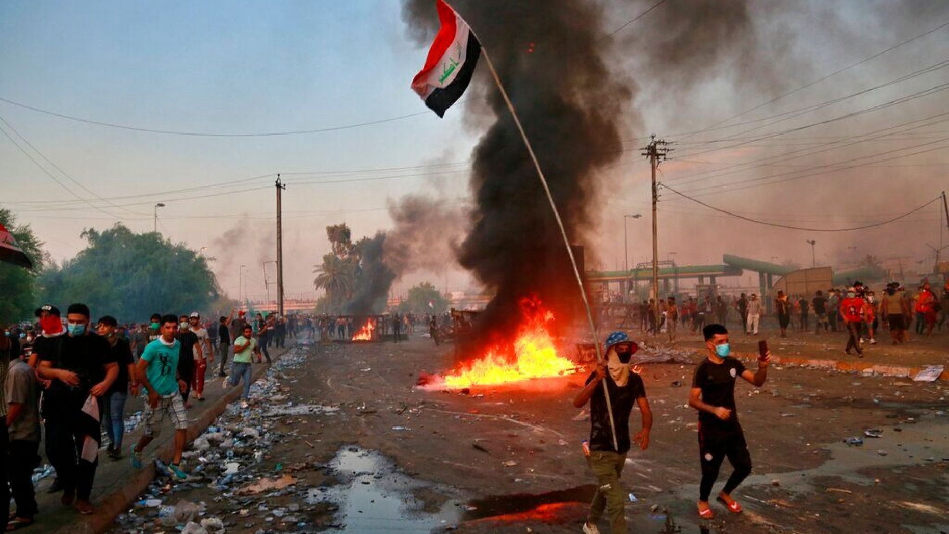 Anti-government protesters set fires and close a street during a demonstration in Baghdad, Iraq, Thursday, Oct. 3, 2019. 