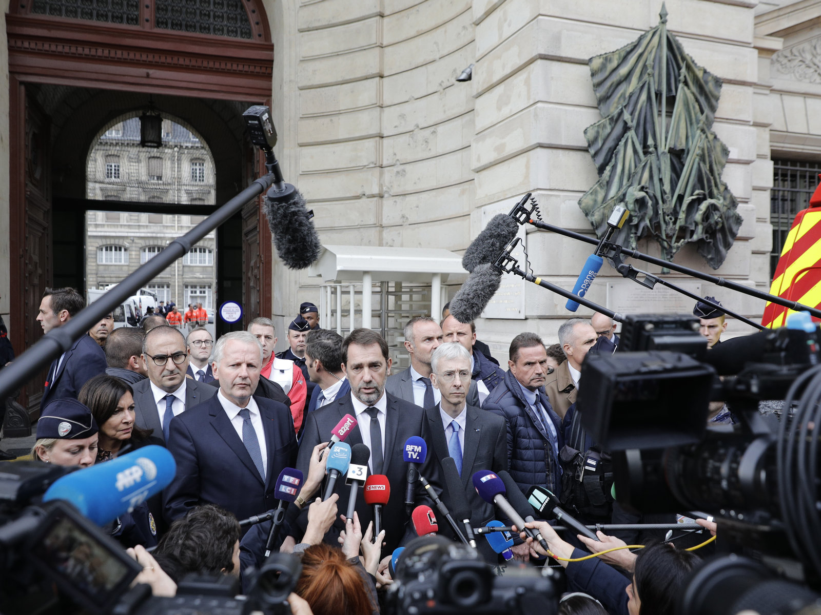 French Interior Minister Christophe Castaner, center, and Paris police leader Didier Lallement, right, give a press conference outside the police headquarters in Paris.