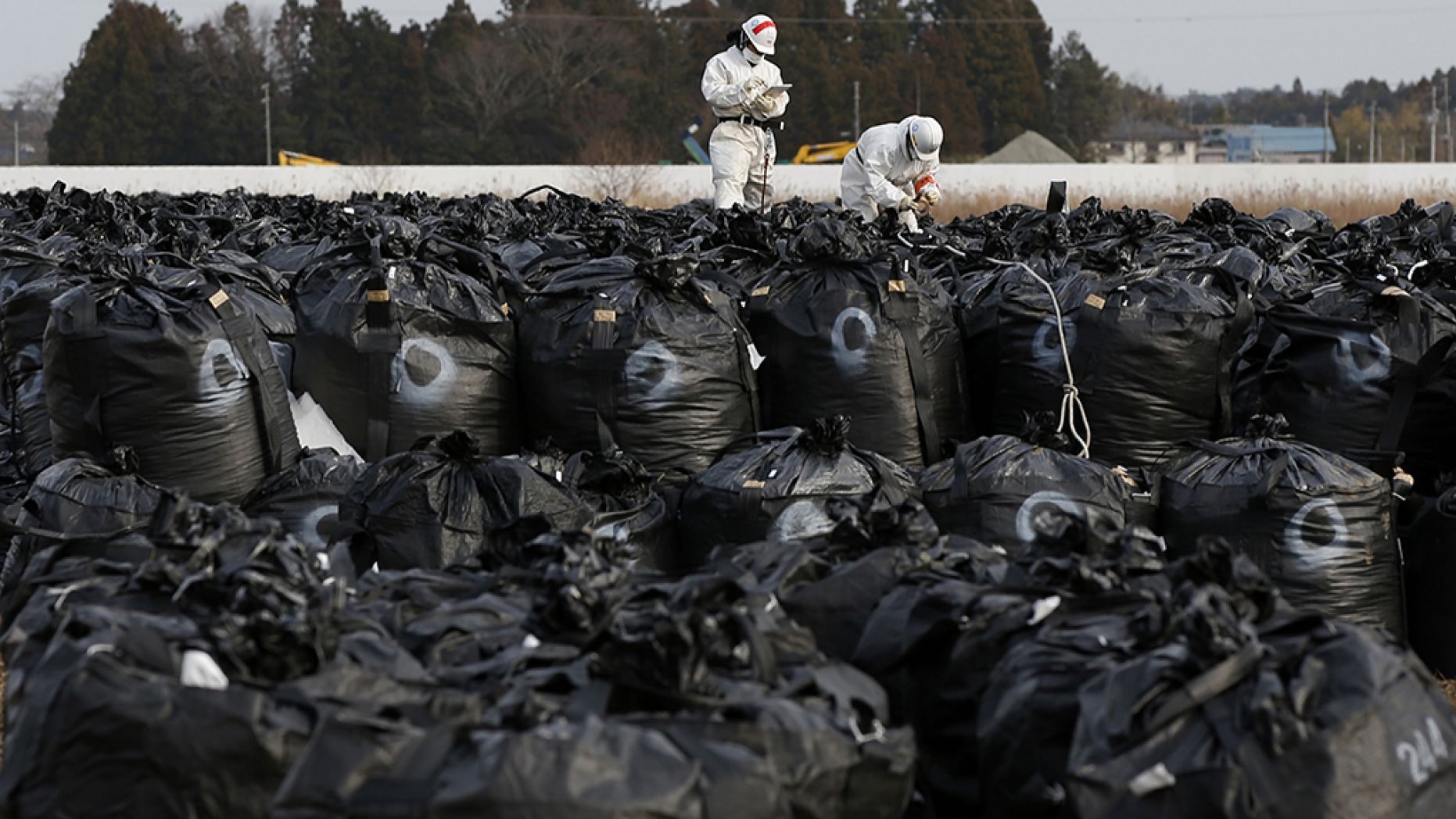 Plastic bags containing greenery collected during decontamination efforts after the 2011 Japanese nuclear disaster were washed down a river during Typhoon Hagibis.