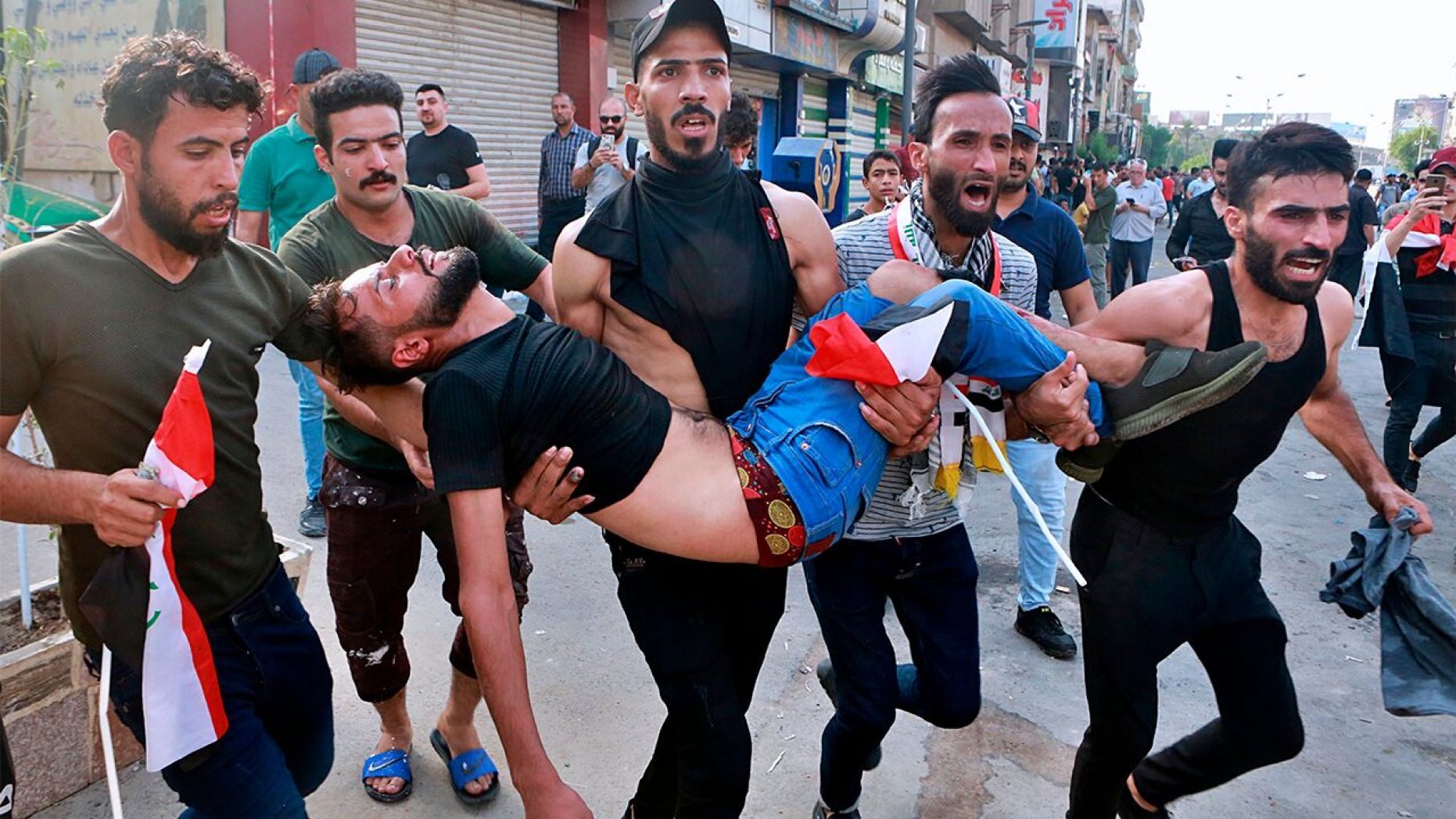 An injured protester is carried off during a protest in Baghdad, Iraq, on Tuesday.