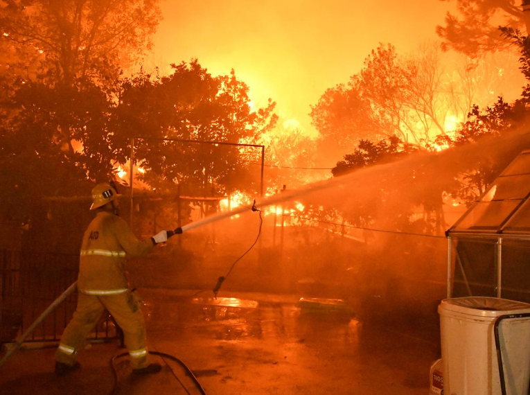 Firefighters battle a wind-driven wildfire in Sylmar, California, U.S., October 11, 2019.