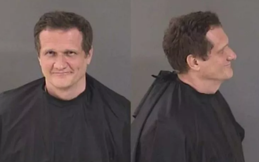 Matthias Ajple, 43, who was charged with battery after he spat on a man wearing a MAGA hat.