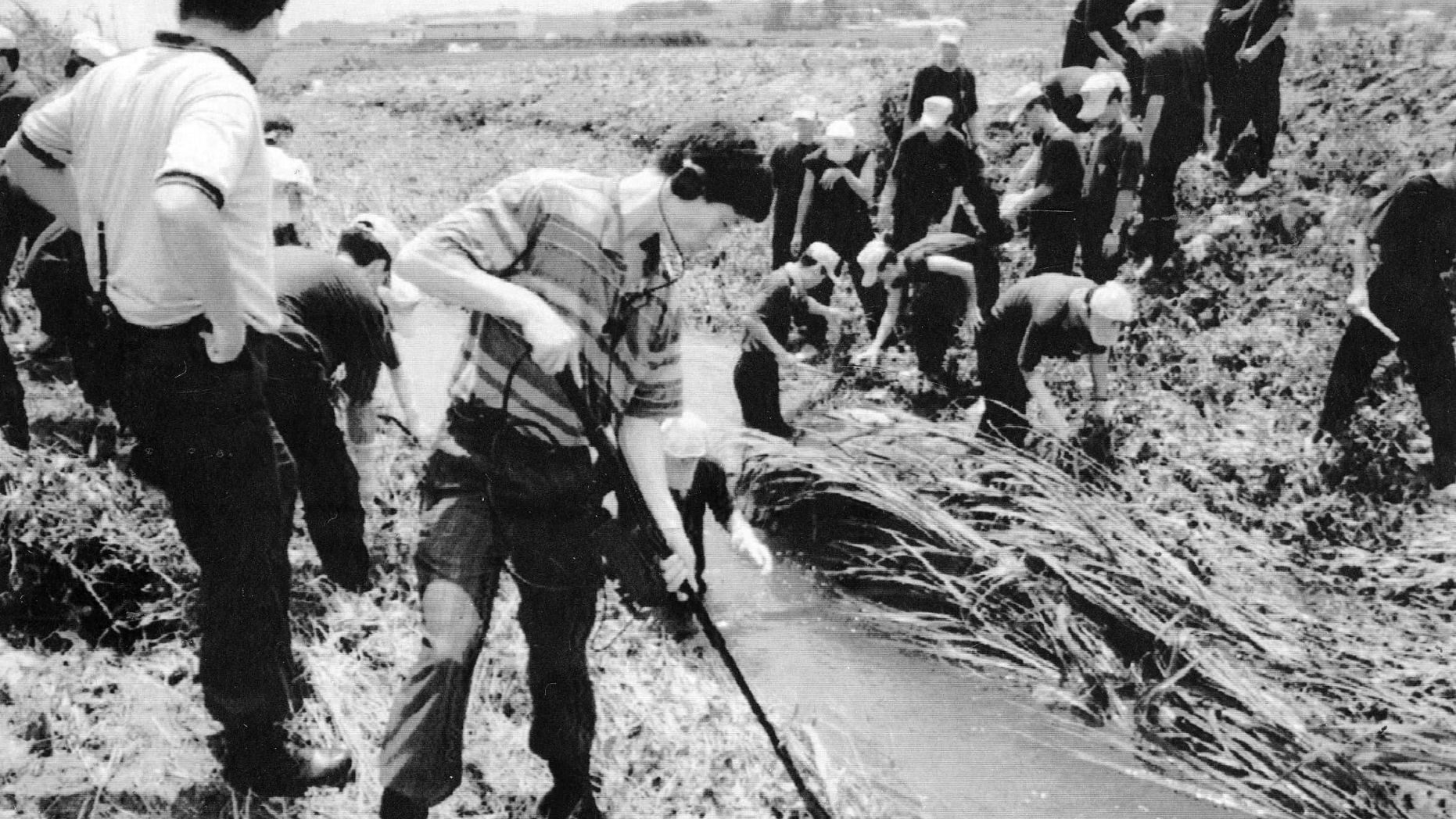 In this July, 1993, photo, South Korean investigators examine the scene following a killing in Hwaseong, South Korea. 