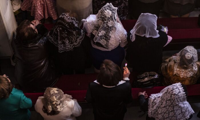 Syriac Christians take part in Palm Sunday celebrations at the Syriac Orthodox Church of the Virgin Mary in the northeastern Syrian Kurdish-controlled city of Qamishli, on April 21, 2019.