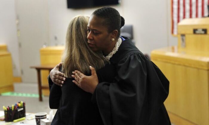 State District Judge Tammy Kemp gives former Dallas Police Officer Amber Guyger a hug before Guyger leaves for jail in Dallas on Oct. 2, 2019.