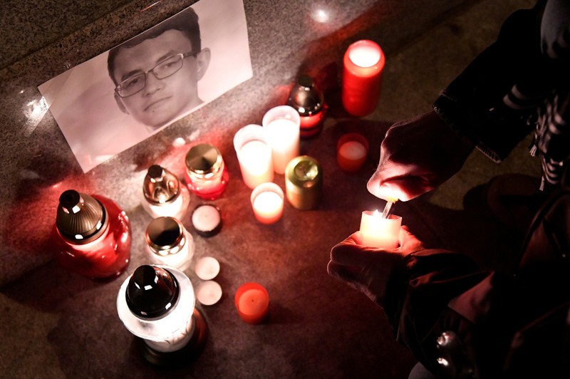 FILE PHOTO: A journalist lights a candle in memory of murdered investigative journalist Jan Kuciak, in Trencin, Slovakia, February 26, 2018. 