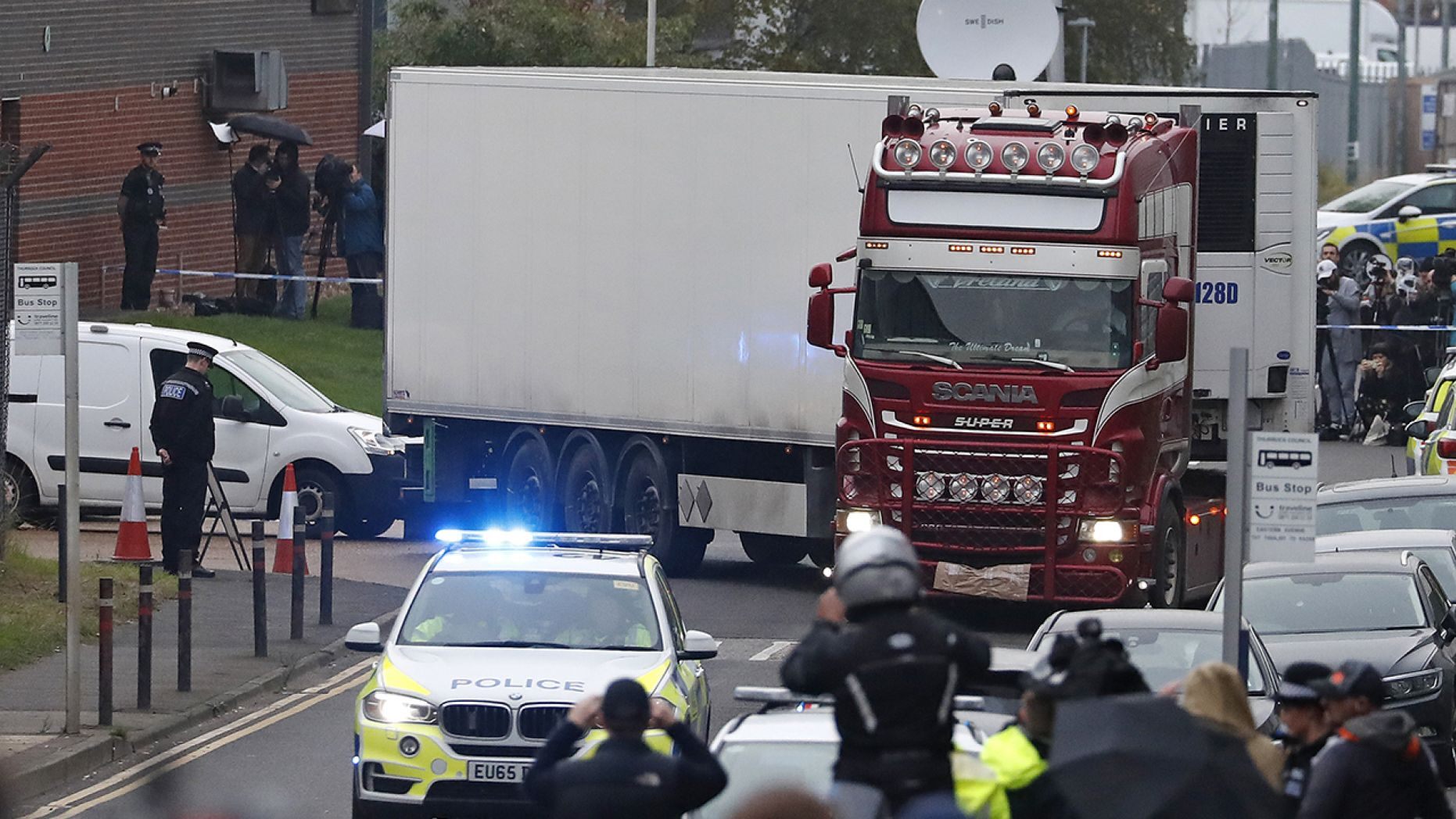 Police escort the truck, that was found to contain a large number of dead bodies, as they move it from an industrial estate in Thurrock, south England, Wednesday Oct. 23, 2019. Police in southeastern England said that 39 people were found dead Wednesday inside a truck container believed to have come from Bulgaria. 
