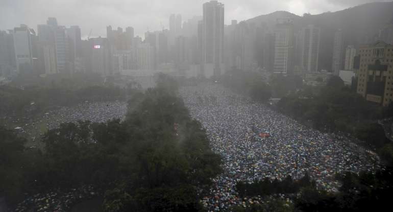 Protesters gather on Victoria Park in Hong Kong Sunday, Aug. 18, 2019.