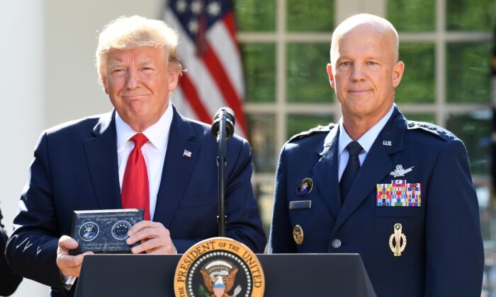General John W. Raymond (R) and President Donald Trump pose during an event establishing the US Space Command in the Rose Garden of the White House in Washington, on Aug. 29, 2019. 