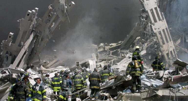 Firefighters make their way through the rubble after two airliners crashed into the World Trade Center in New York bringing down the landmark buildings Tuesday, Sept. 11, 2001. 